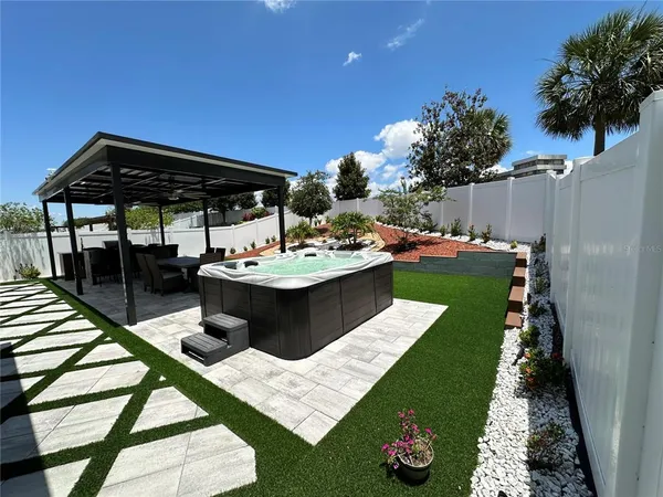 a view of a backyard with sitting area