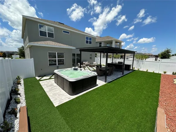 a backyard of a house with table and chairs