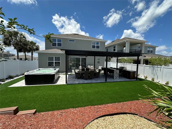 a view of a house with a swimming pool and sitting area
