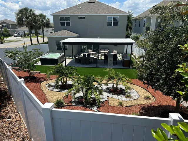 a view of a chairs and table in patio with a barbeque grill