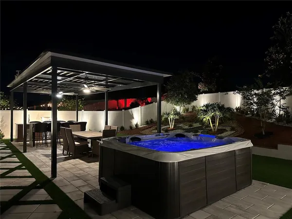 a front view of a house with yard fountain and outdoor seating