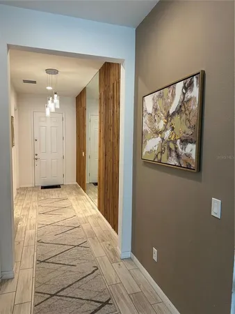 a view of a hallway with wooden floor