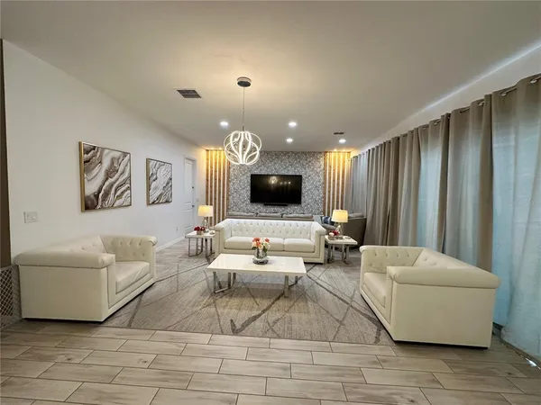 a living room with furniture and a flat screen tv