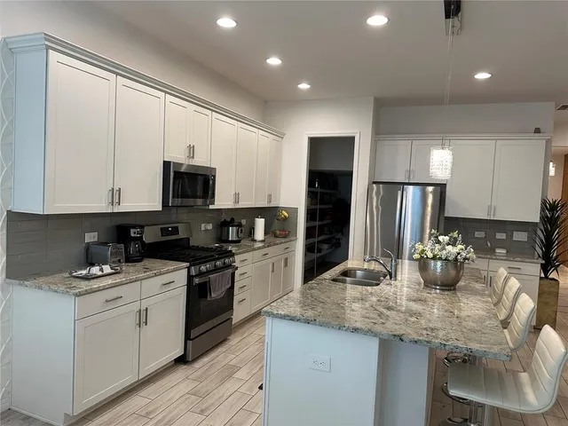 a kitchen with a sink stove and refrigerator