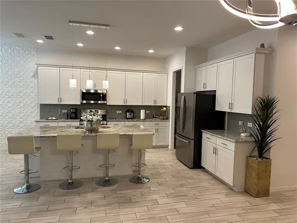 a kitchen with sink and refrigerator
