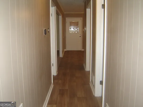 a view of a hallway with wooden floor