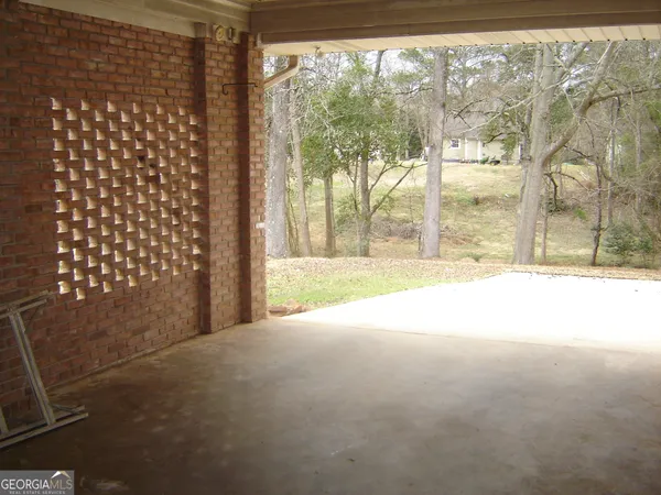 a view of empty room with wooden floor and door