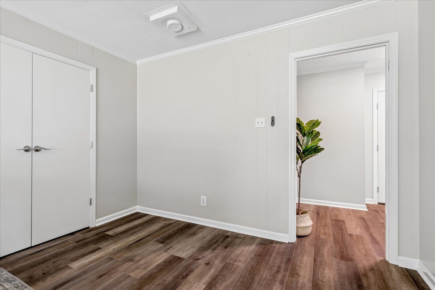 3351 Oak Road Bartlett, TN 38135 - Photo 20 of 30 Wood-finish flooring throughout, bright white trim, and a bi-fold closet door
