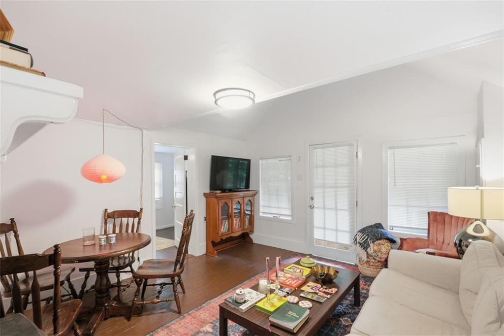 1424 Emory Road Northeast Atlanta, GA 30306 - Photo 31 of 36 a living room with furniture a flat screen tv and kitchen view