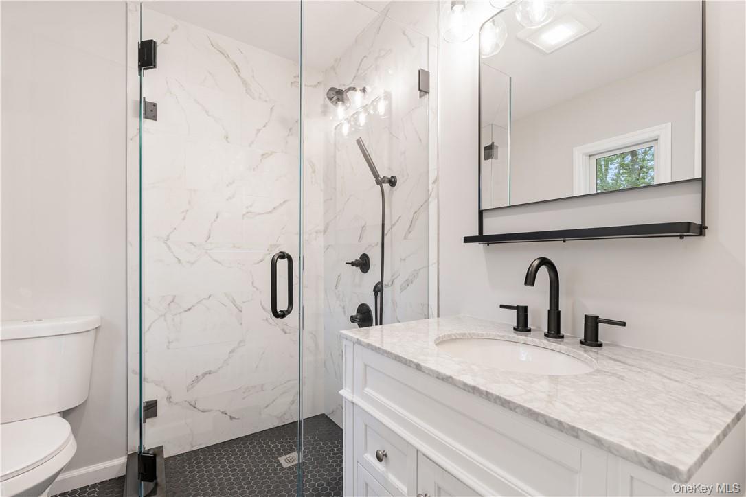 5 Paddock Road Rye Brook, NY 10573 - Photo 11 of 23 Bathroom featuring vanity, toilet, and an enclosed shower