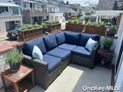 a balcony with furniture and a potted plant