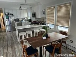 a kitchen with a sink a microwave a refrigerator and cabinets