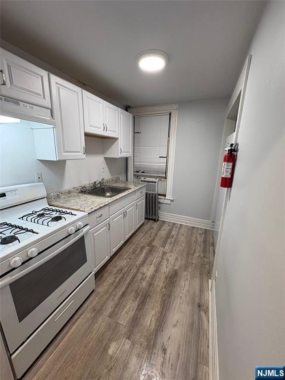 195 Ramapo Valley Road, Unit 2A Oakland, NJ 07436 - Photo 2 of 5 a kitchen with stainless steel appliances granite countertop a stove and a refrigerator