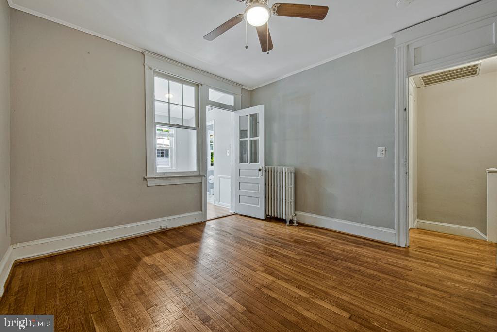 2406 37th Street Northwest Washington, DC 20007 - Photo 5 of 44 a view of an empty room with wooden floor and a window