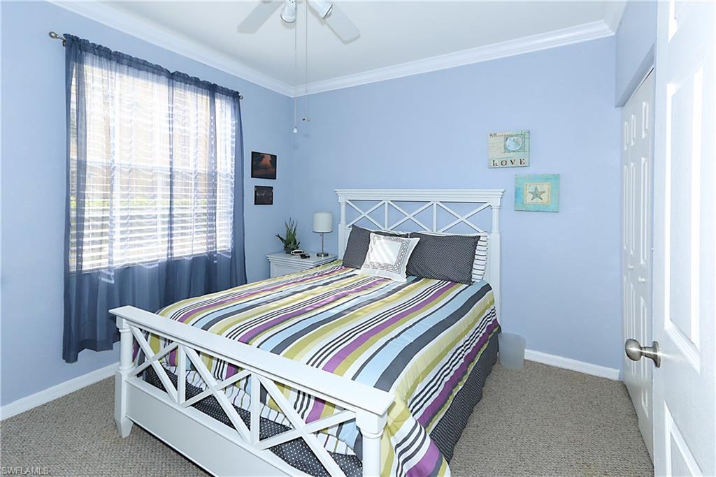 4670 St Croix Lane, Unit 618 Naples, FL 34109 - Photo 13 of 19 a bed sitting in a bedroom next to a window