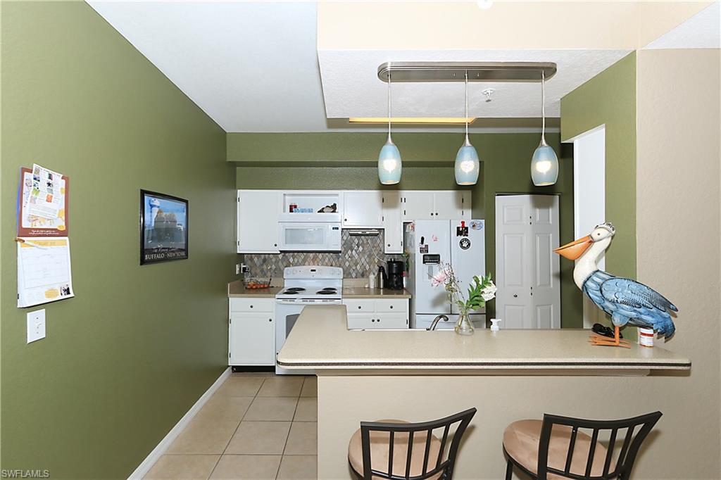 4670 St Croix Lane, Unit 618 Naples, FL 34109 - Photo 4 of 19 a room with stainless steel appliances and cabinets