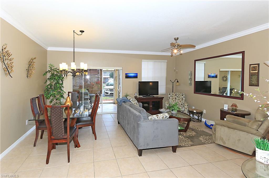 4670 St Croix Lane, Unit 618 Naples, FL 34109 - Photo 6 of 19 a living room with furniture and a flat screen tv