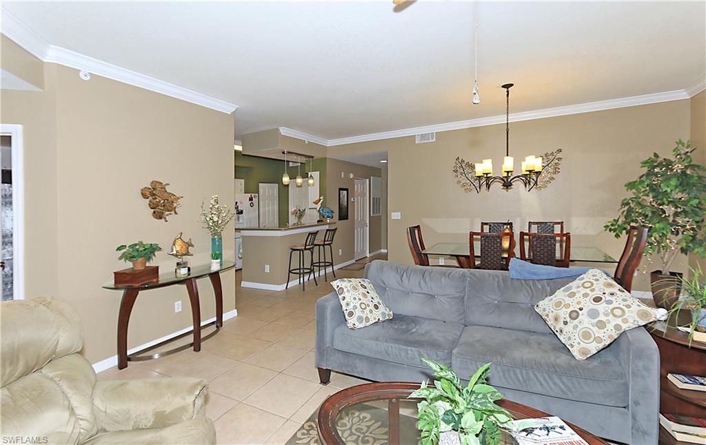 4670 St Croix Lane, Unit 618 Naples, FL 34109 - Photo 9 of 19 a living room with furniture chandelier and a chandelier