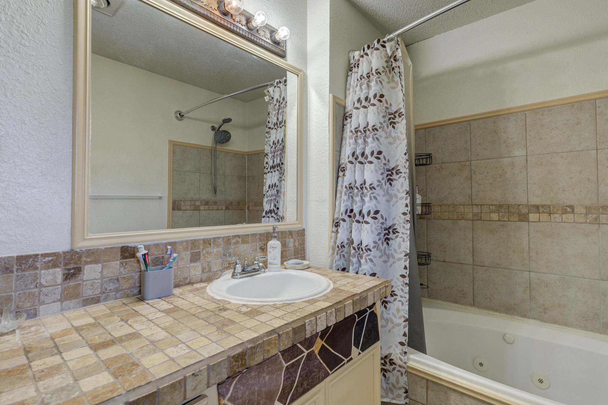 2901 Beech Avenue Lubbock, TX 79404 - Photo 20 of 26 a bathroom with a sink a toilet and shower