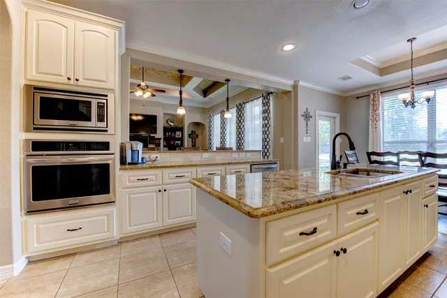 a kitchen with stainless steel appliances granite countertop a sink and dishwasher a stove with wooden floor