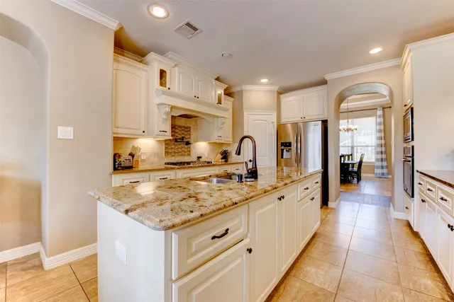 a large kitchen with stainless steel appliances lots of counter space and wooden floor