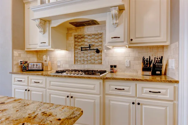 a kitchen with stainless steel appliances granite countertop a sink and cabinets with wooden floor