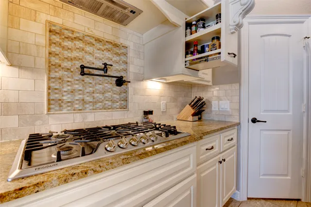 a kitchen with a stove and a cabinet