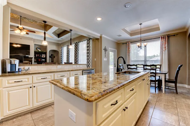 a kitchen with stainless steel appliances granite countertop a sink and cabinets