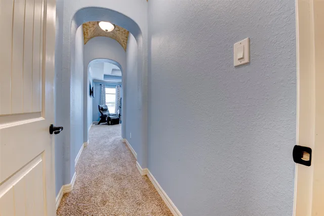 a living room with furniture gym equipment and a chandelier