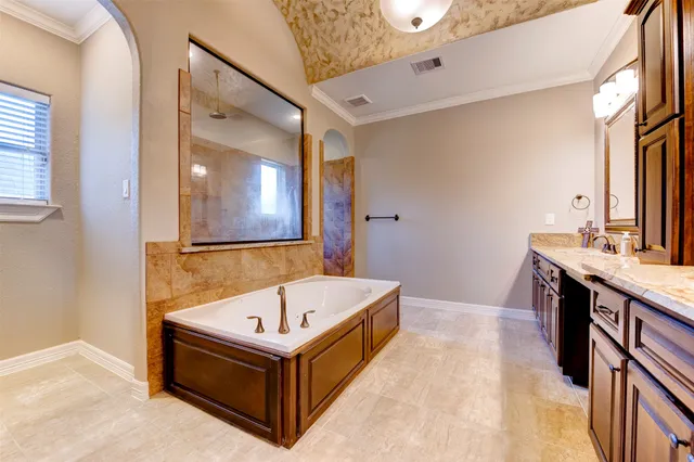 a bathroom with a tub and shower