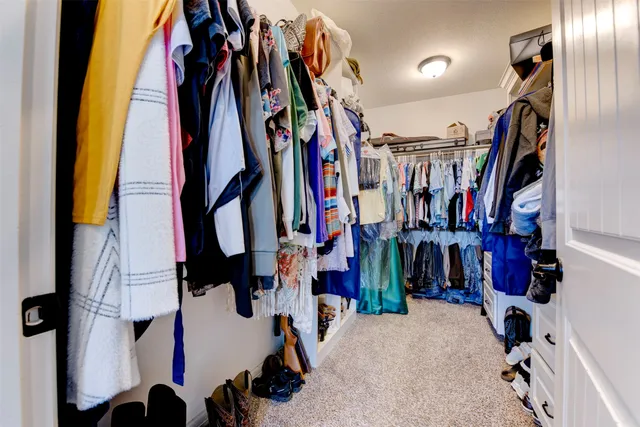 a view of a hallway with wooden floor and closet