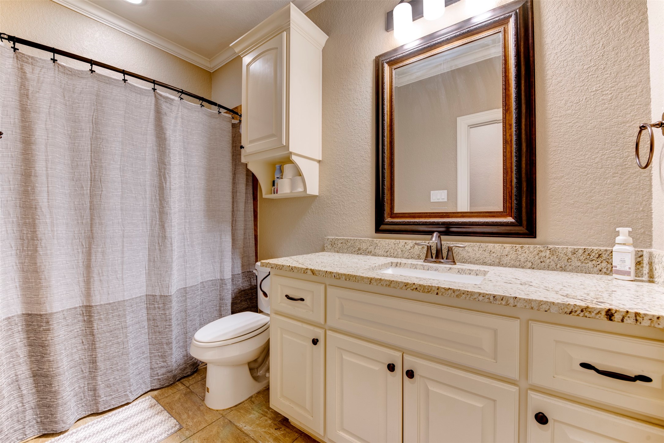 27635 Rio Blanco Drive Splendora, TX 77372 - Photo 37 of 46 a bathroom with a granite countertop sink toilet and mirror