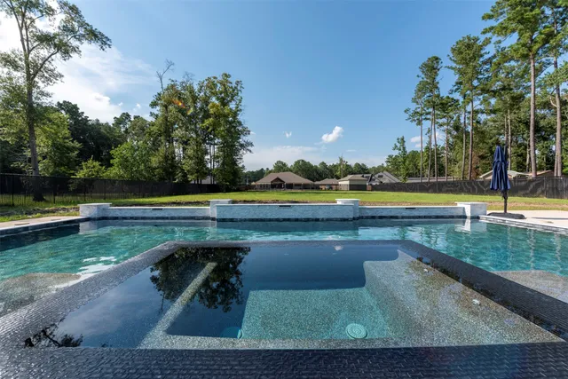a view of swimming pool with a yard and sitting area