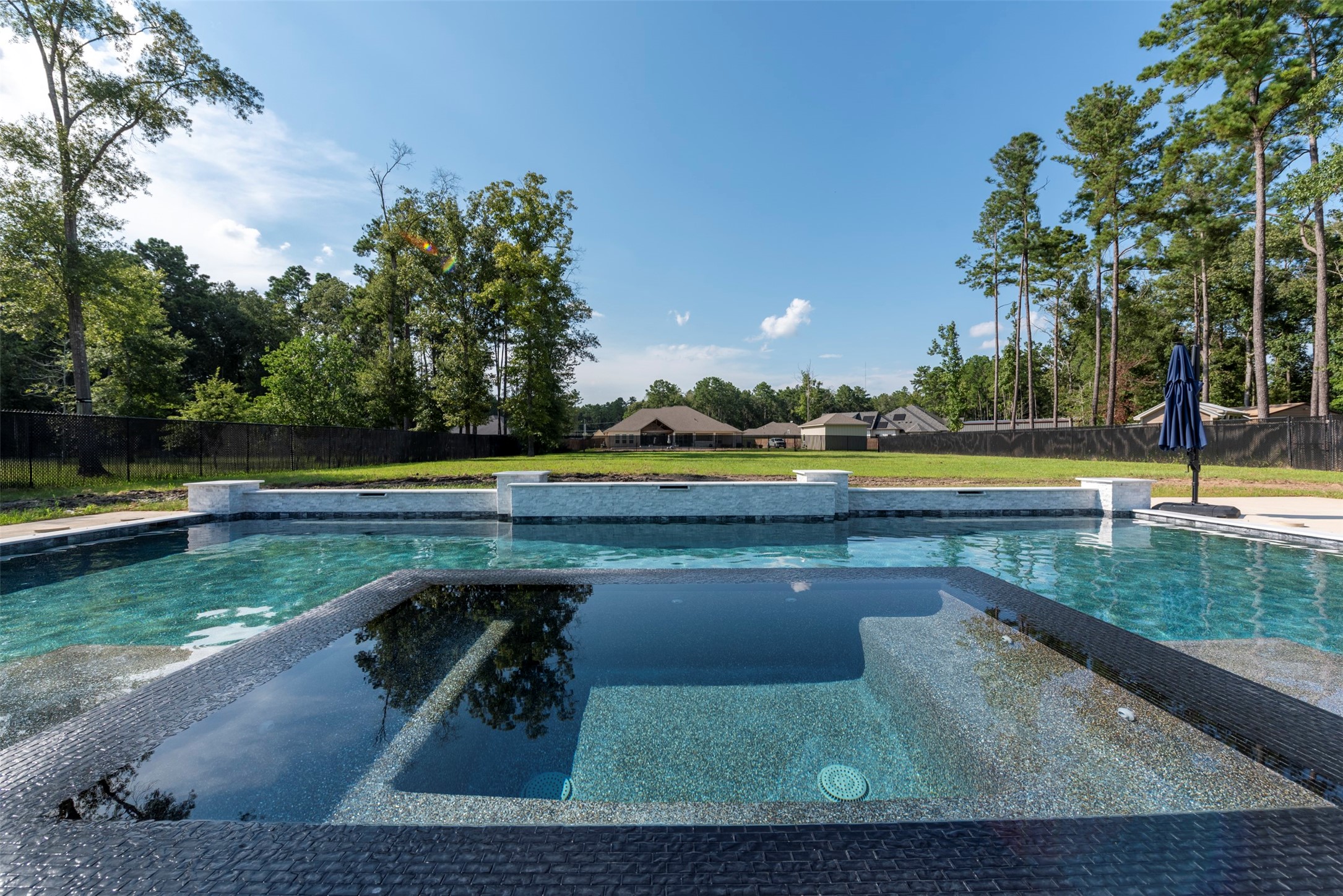 27635 Rio Blanco Drive Splendora, TX 77372 - Photo 40 of 46 a view of a lake with a yard