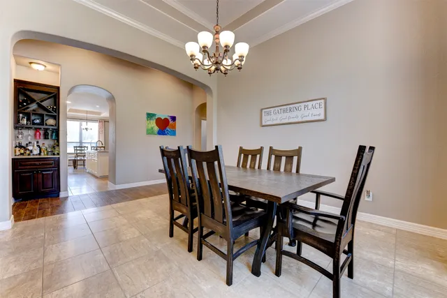 a view of a dining room with furniture and chandelier