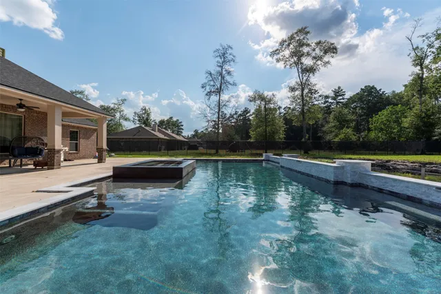 a view of a house with a yard and sitting area