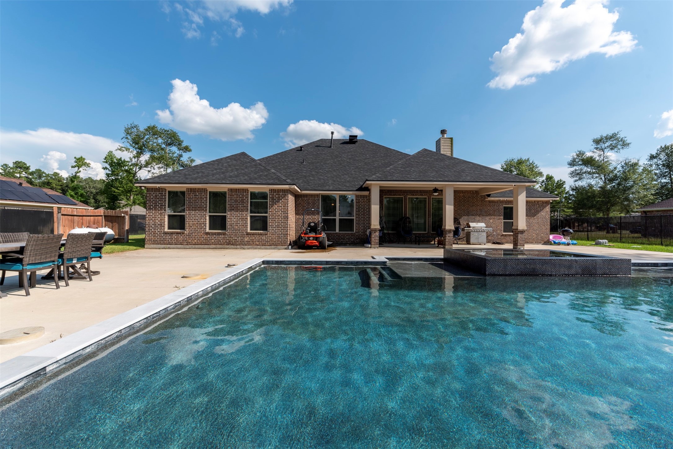 27635 Rio Blanco Drive Splendora, TX 77372 - Photo 43 of 46 a swimming pool view with a seating space and a garden