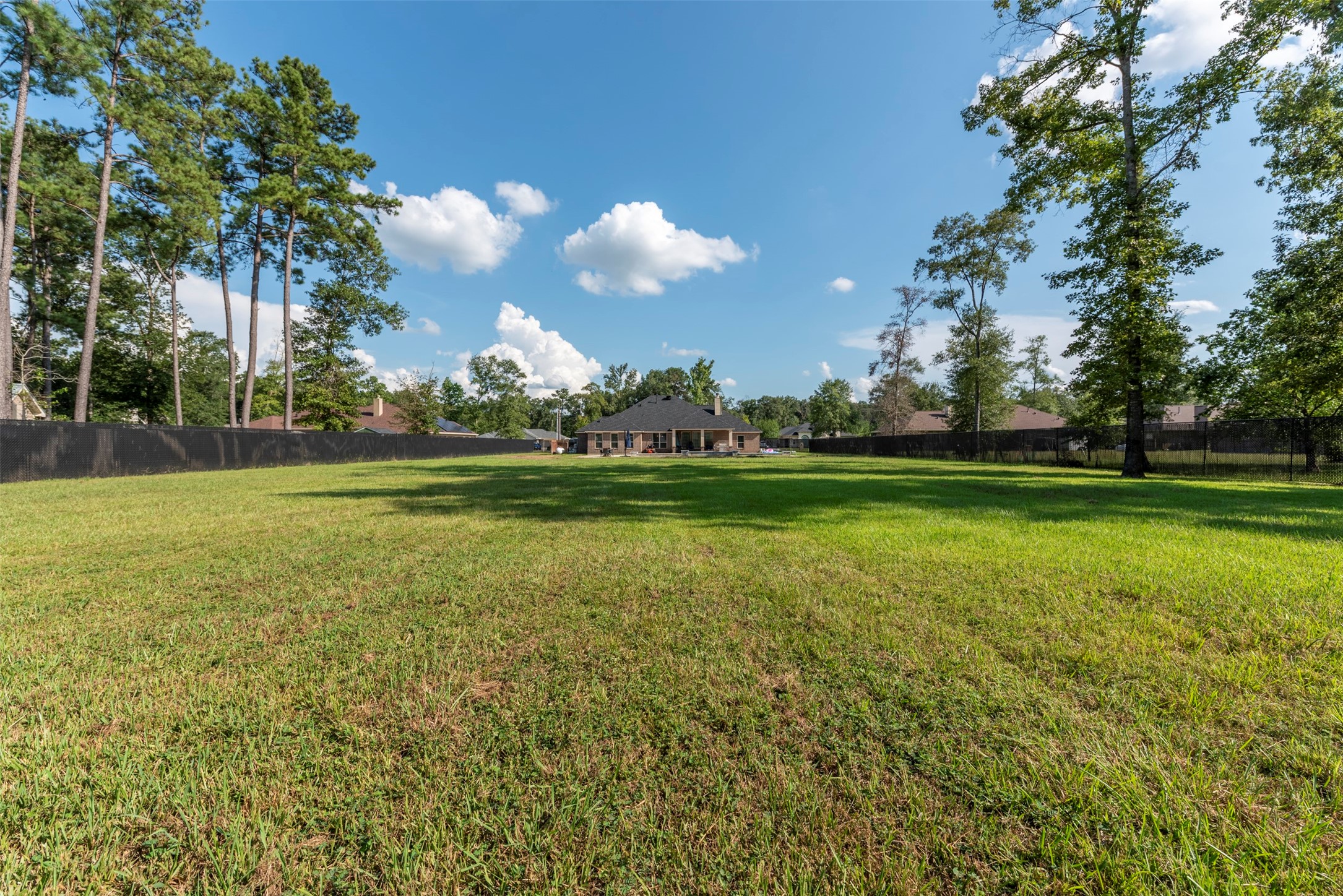 27635 Rio Blanco Drive Splendora, TX 77372 - Photo 45 of 46 a view of a golf course with a lake
