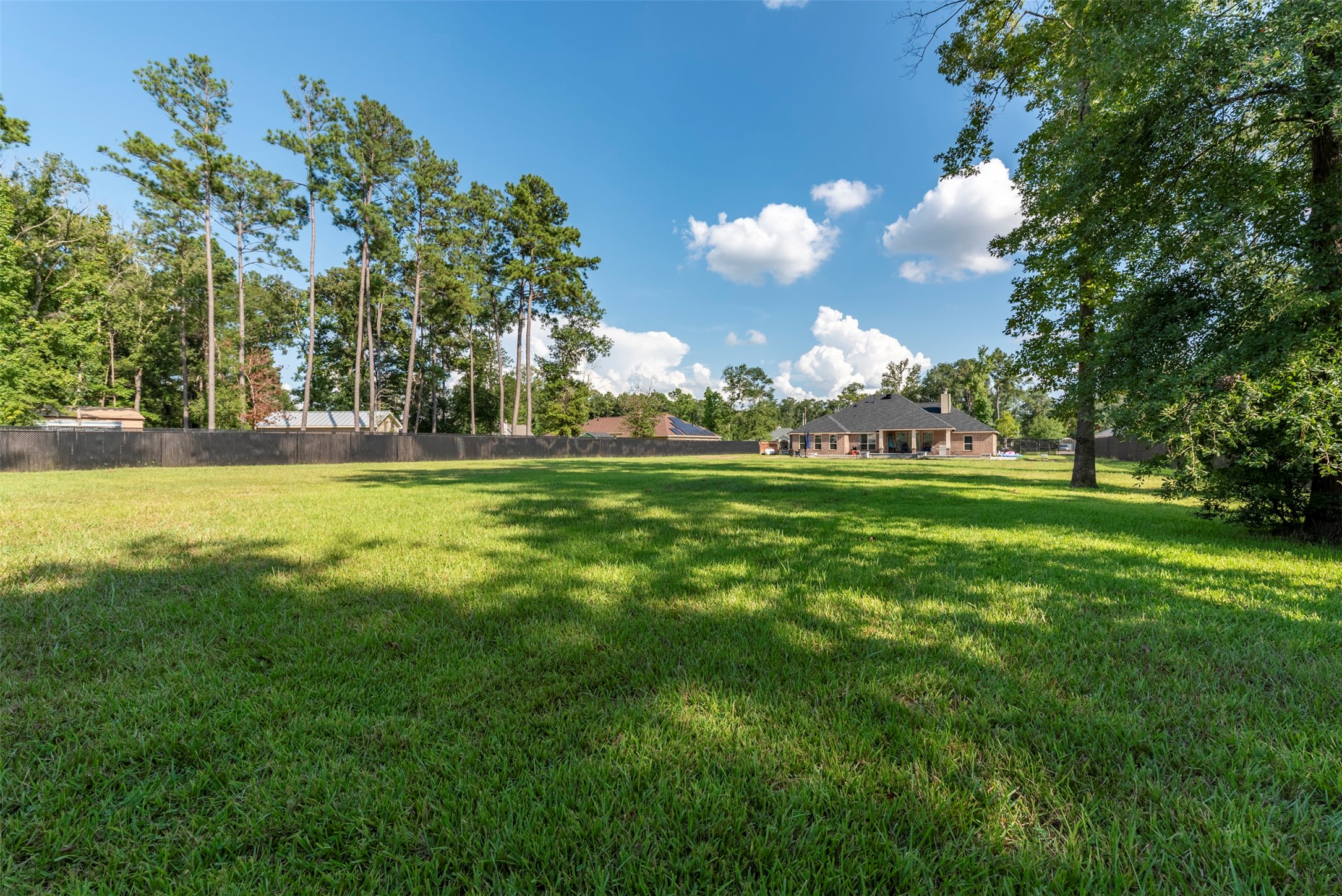 27635 Rio Blanco Drive Splendora, TX 77372 - Photo 46 of 46 a view of a golf course with a lake