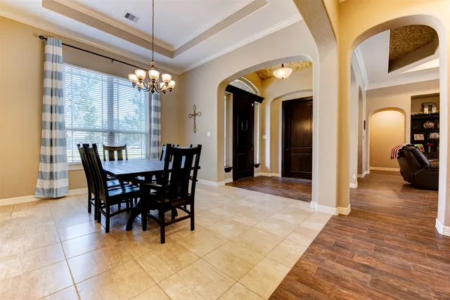 a view of a dining room with furniture and a chandelier