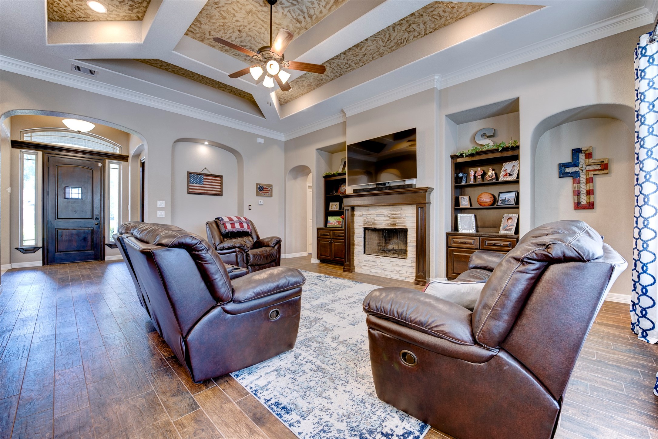 27635 Rio Blanco Drive Splendora, TX 77372 - Photo 8 of 46 a living room with furniture a flat screen tv and a fireplace