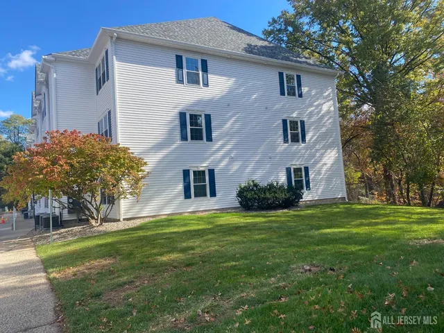 a front view of house with yard and trees