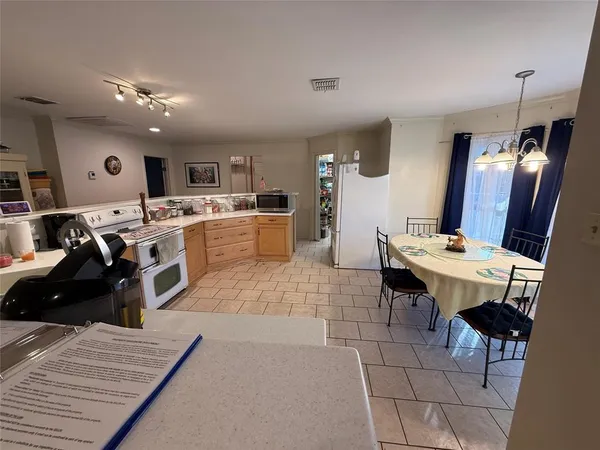 a bedroom with a bed and a flat tv screen on dresser