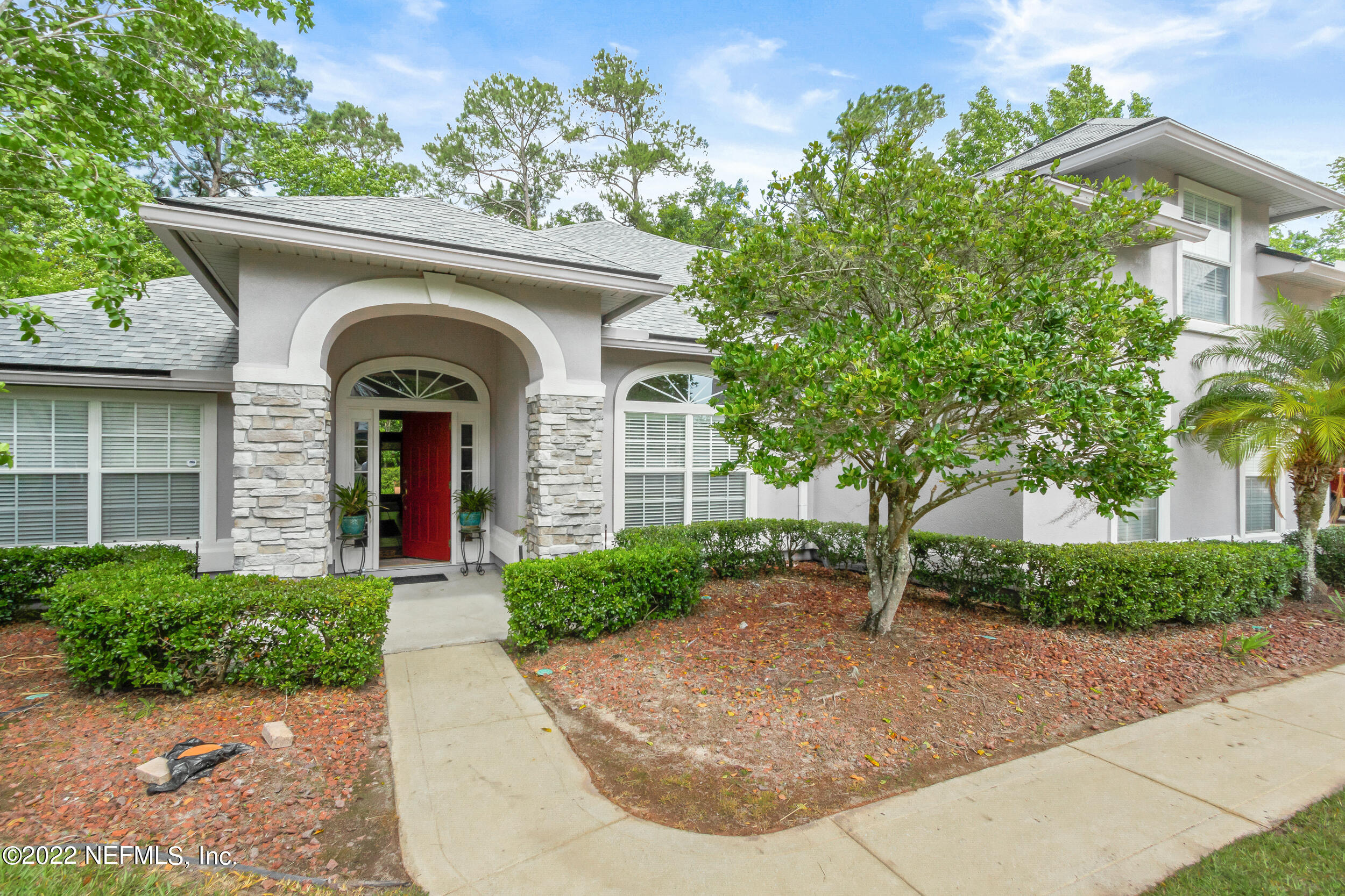 1304 Paradise Pond Road St. Augustine, FL 32092 - Photo 11 of 48 a front view of a house with a garden