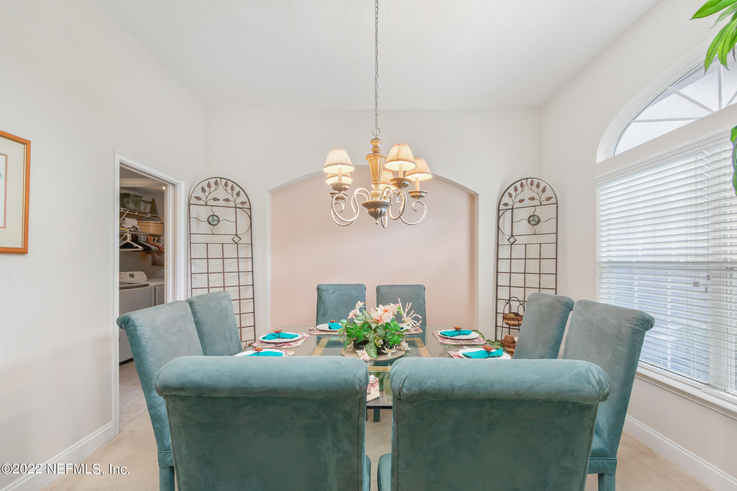 1304 Paradise Pond Road St. Augustine, FL 32092 - Photo 14 of 48 a living room with furniture a chandelier and a window