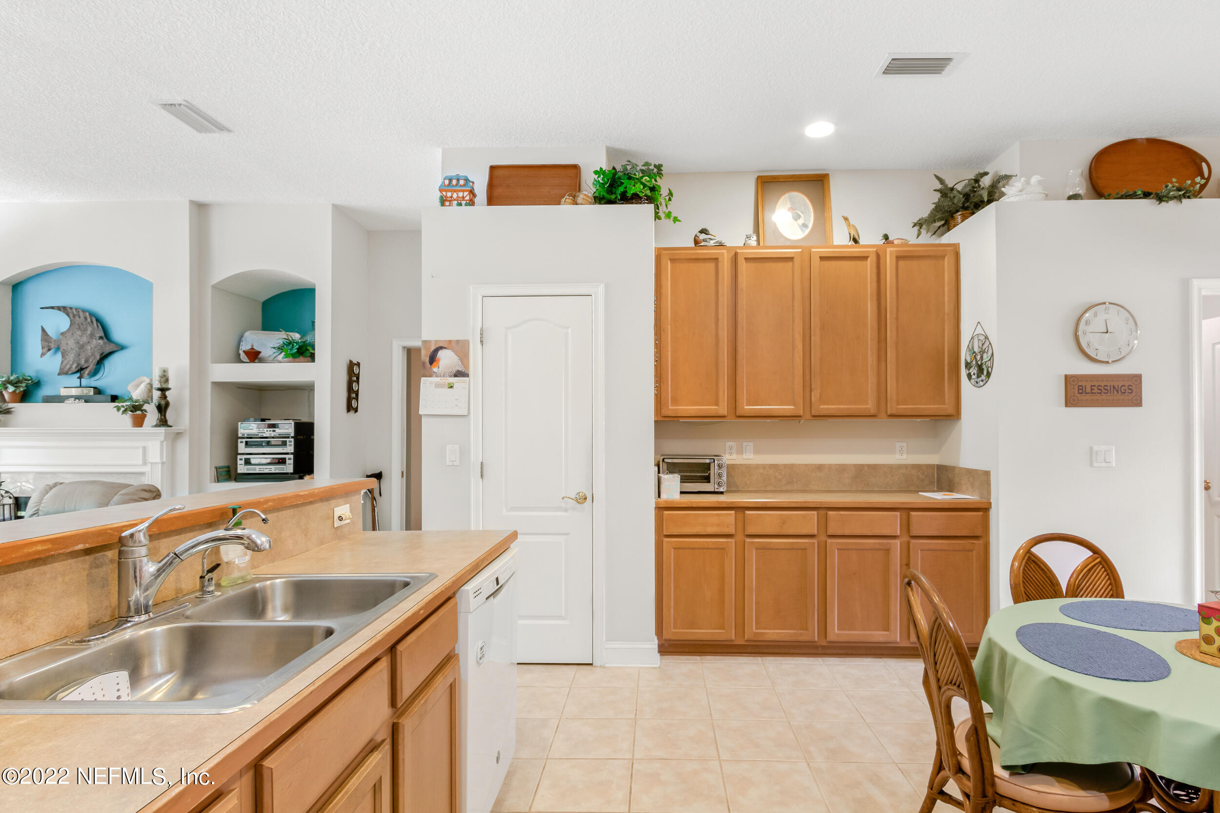 1304 Paradise Pond Road St. Augustine, FL 32092 - Photo 23 of 48 a kitchen with a sink refrigerator and cabinets