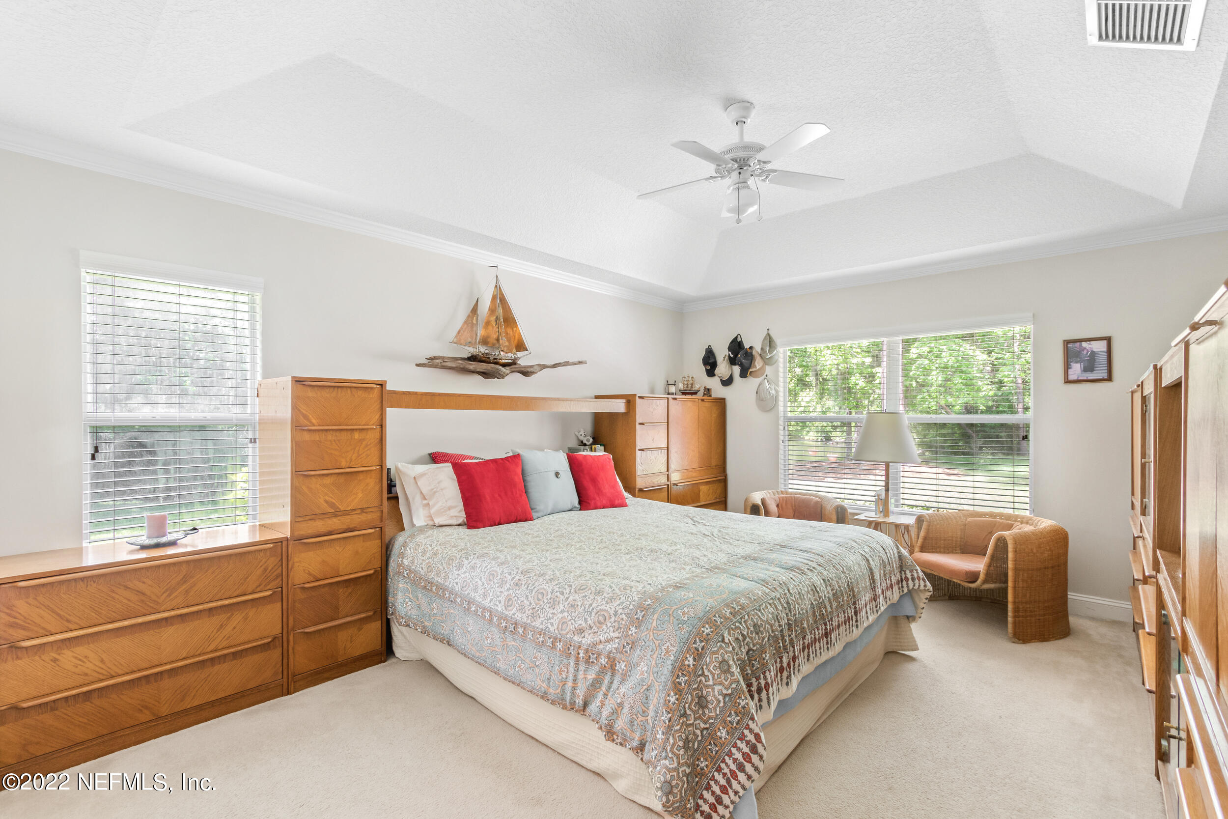 1304 Paradise Pond Road St. Augustine, FL 32092 - Photo 24 of 48 a bedroom with a large bed and a chandelier