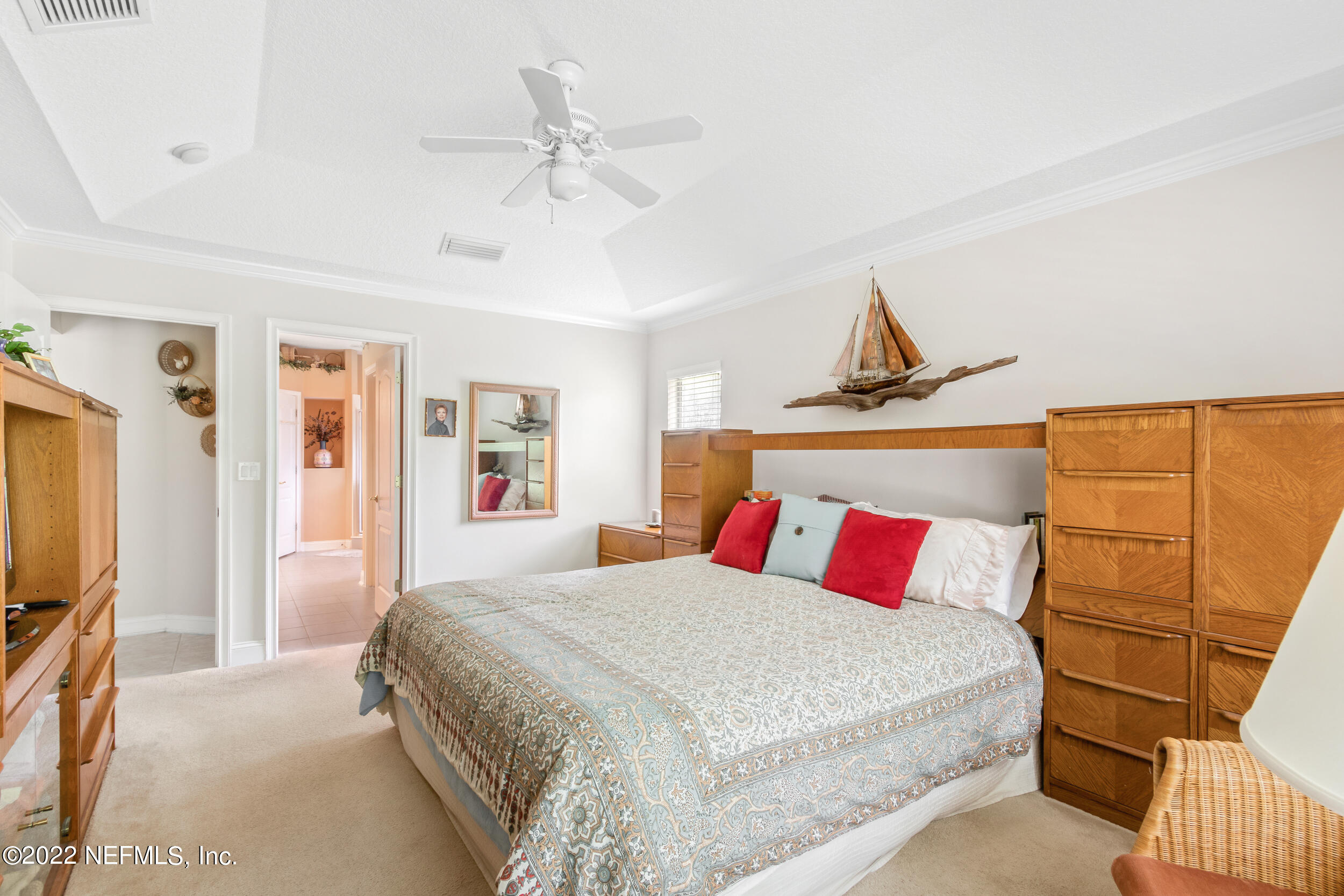 1304 Paradise Pond Road St. Augustine, FL 32092 - Photo 25 of 48 a bedroom with a bed and a flat screen tv