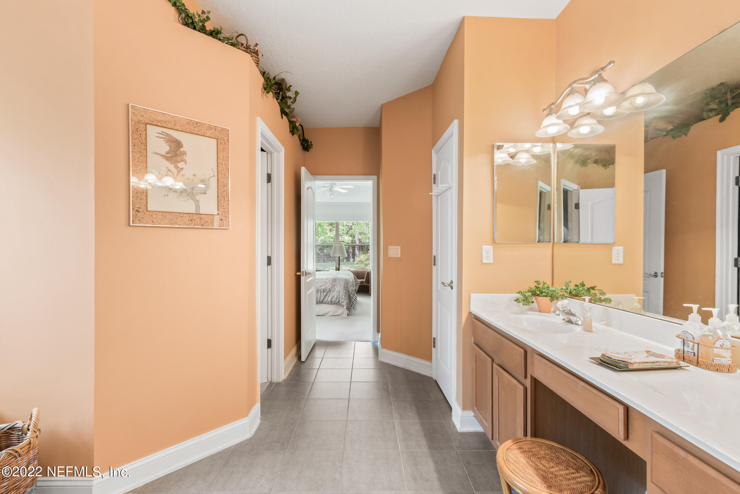 1304 Paradise Pond Road St. Augustine, FL 32092 - Photo 26 of 48 a spacious bathroom with a double vanity sink a mirror and a shower