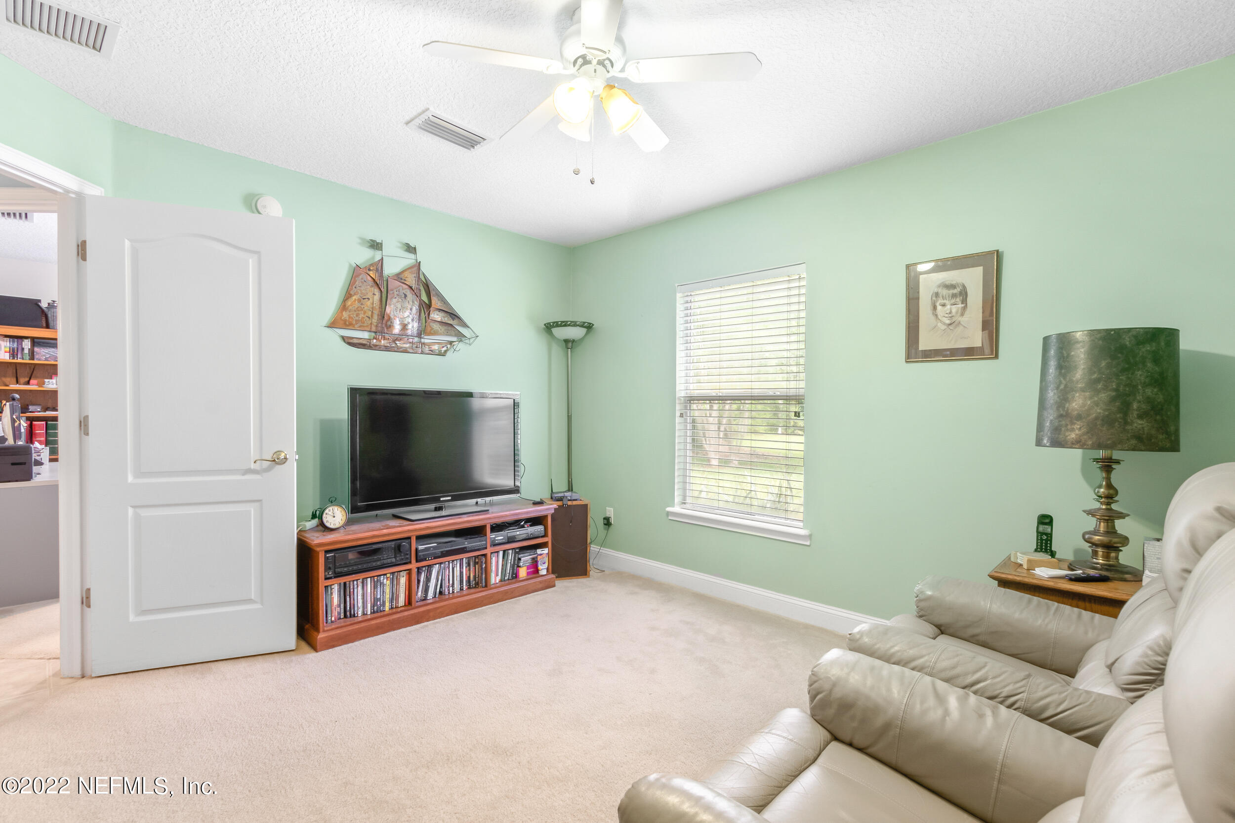 1304 Paradise Pond Road St. Augustine, FL 32092 - Photo 31 of 48 a living room with furniture and a flat screen tv